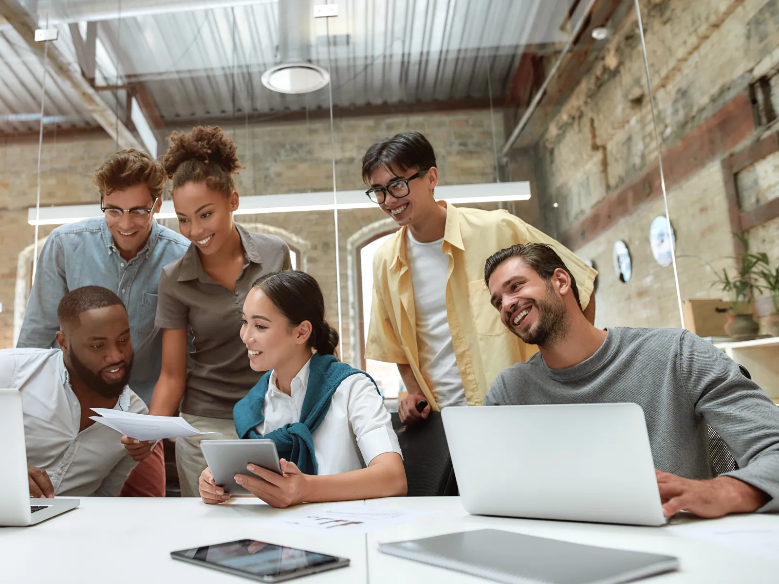 a group of people looking at a laptop