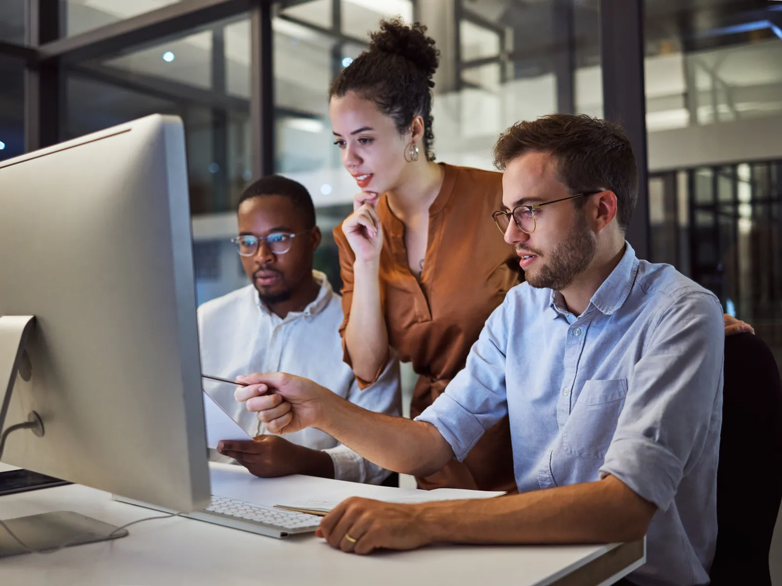 a group of people looking at a computer screen