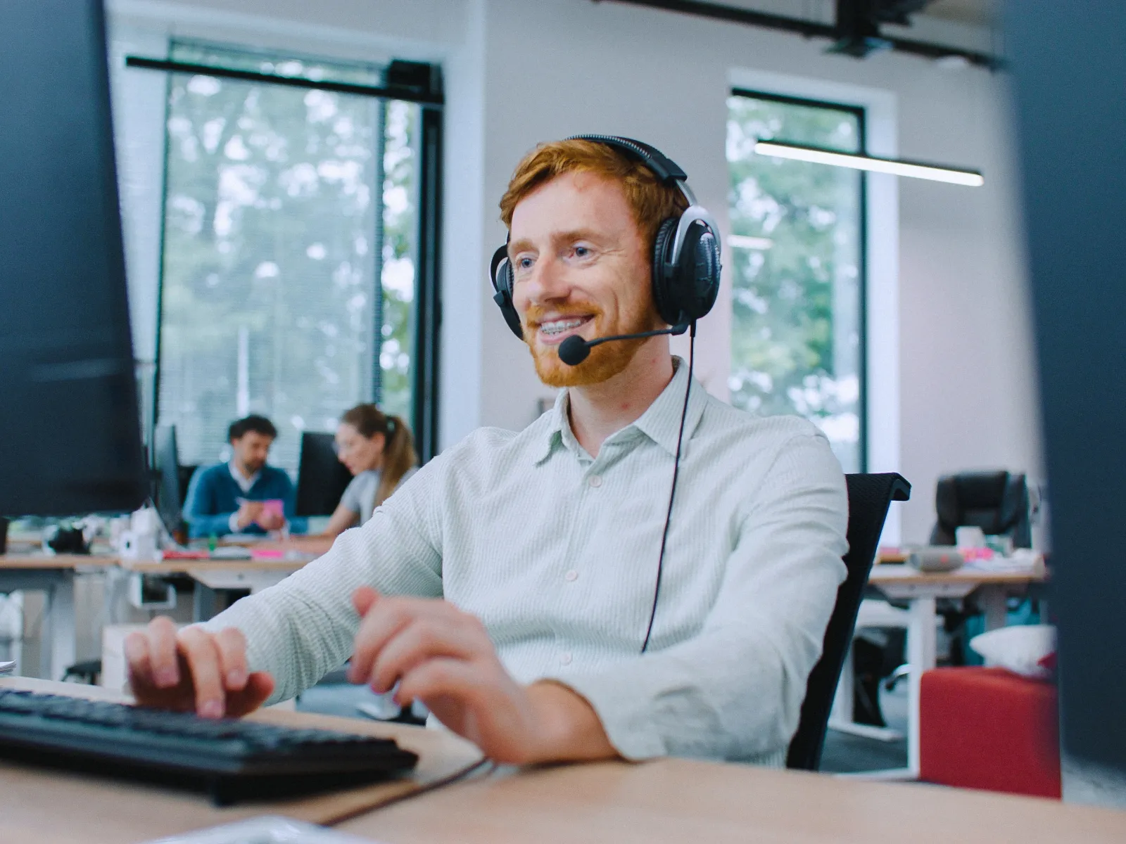 a man wearing headphones and sitting at a desk