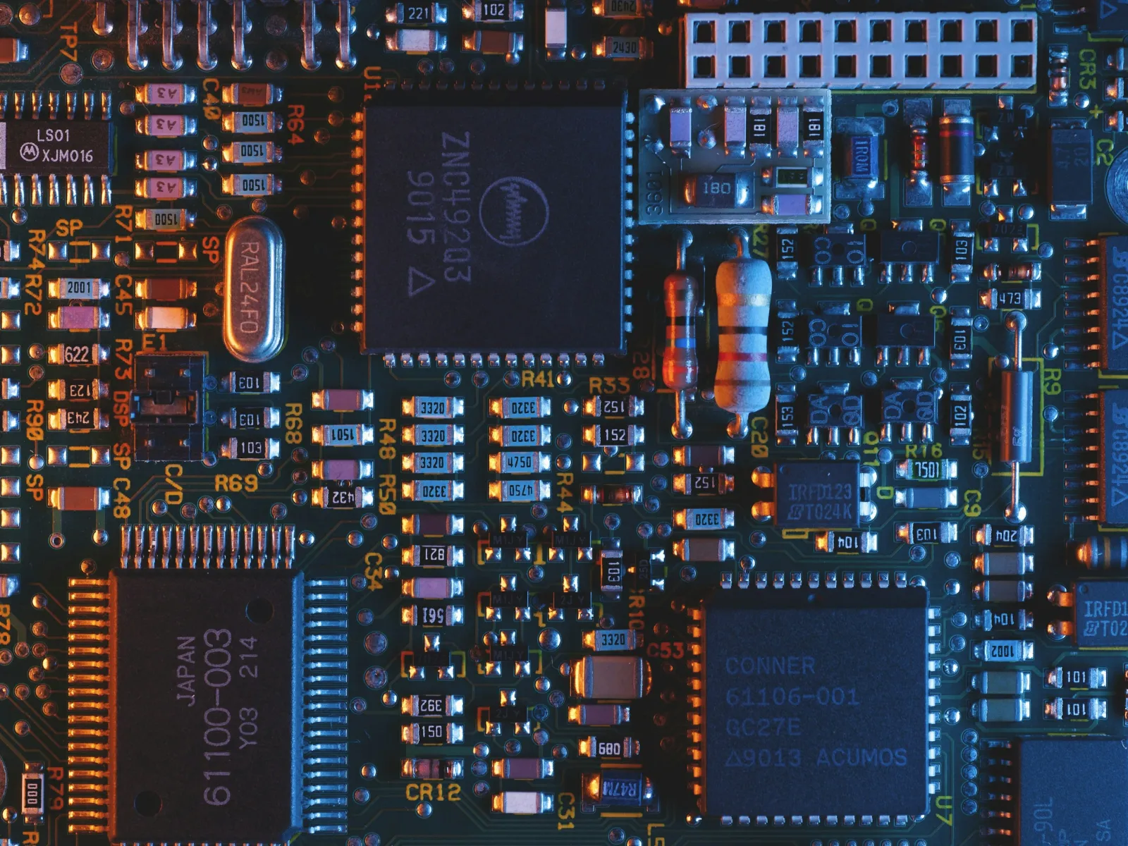 Close-up of a detailed electronic circuit board with integrated chips, resistors, and capacitors.