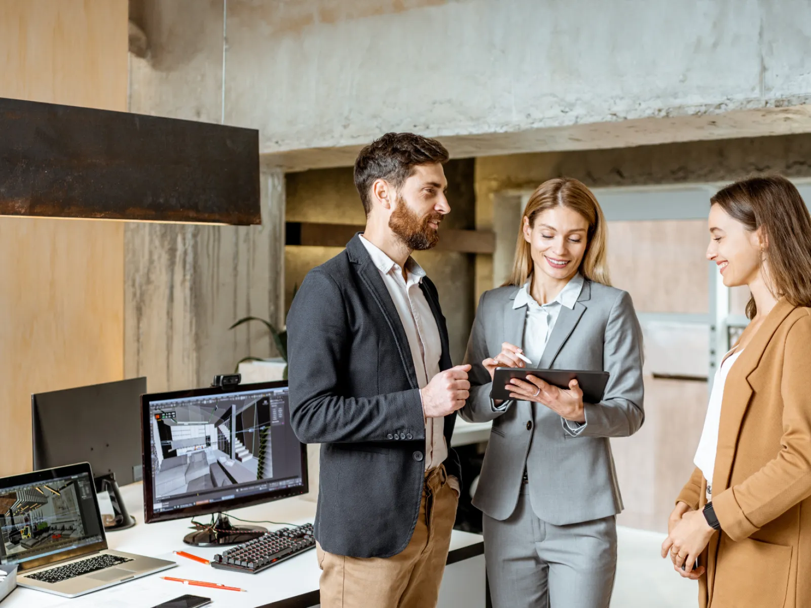 a group of people standing in front of a computer
