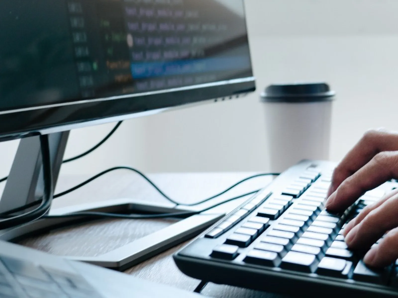 a hand on a keyboard