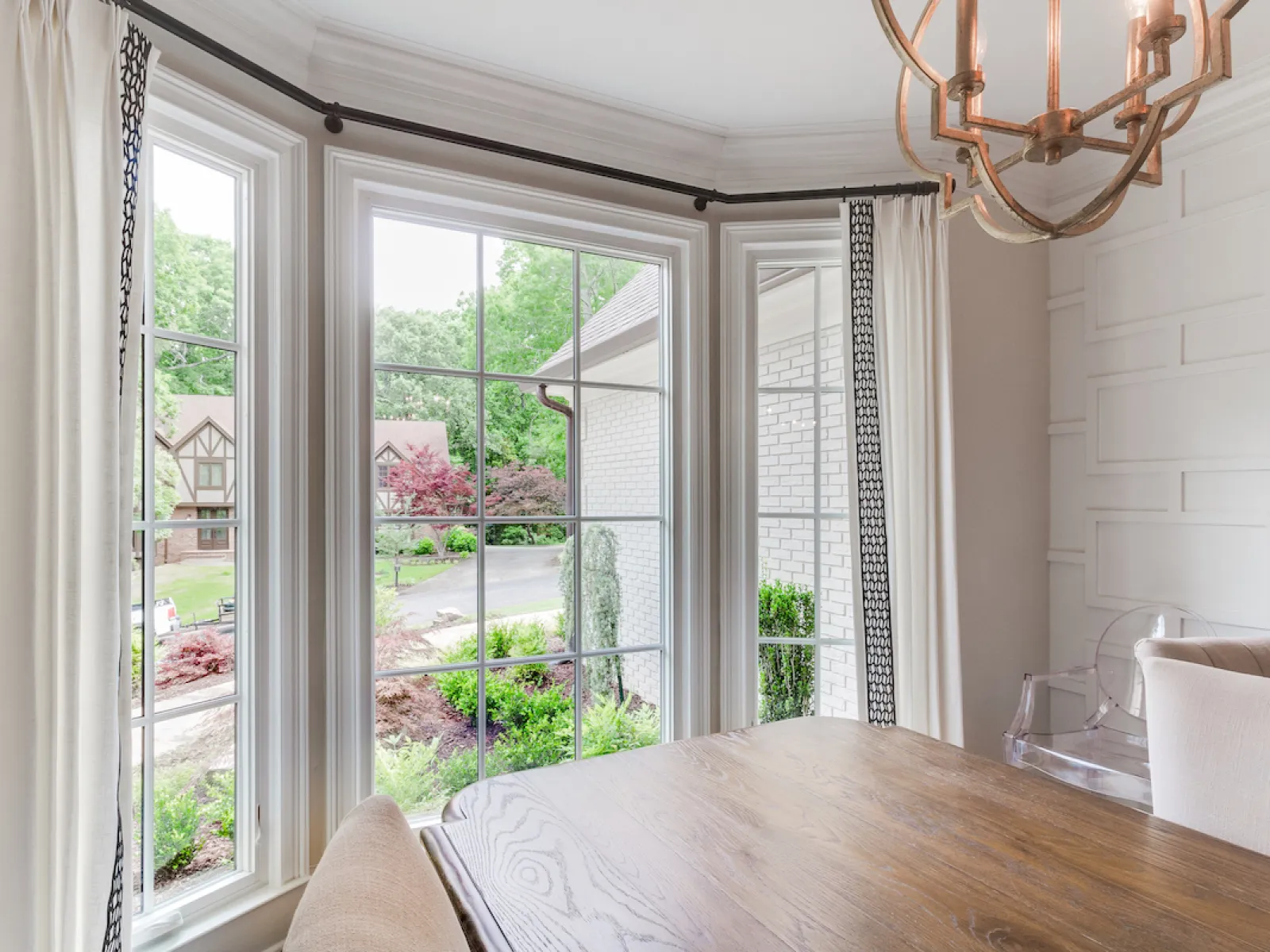 a room with a table and a window with a view of the street