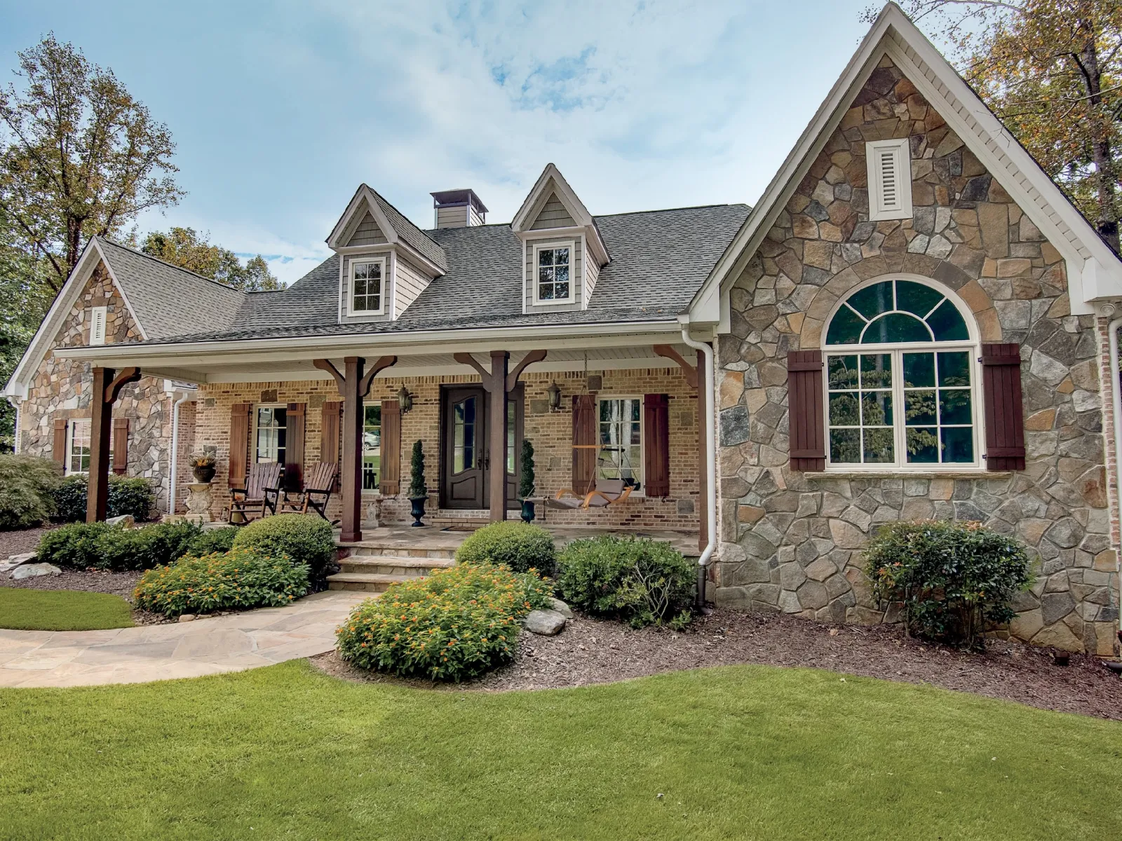 a stone house with a large front yard and window replacements from North Georgia Replacement Windows