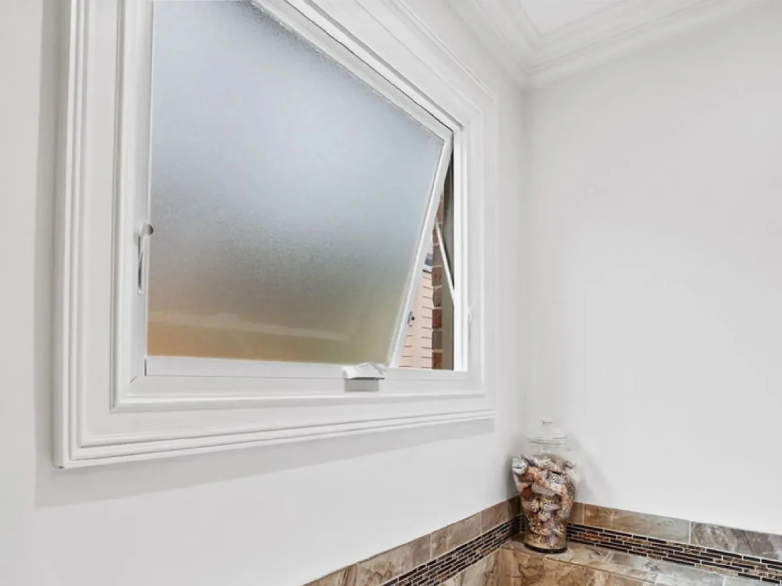 White casement window manufactured by Infinity from Marvin.