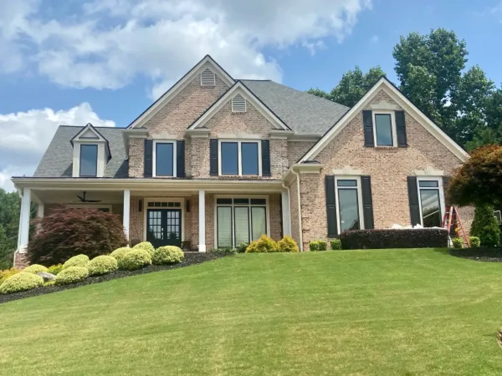 a large brick house with a lawn