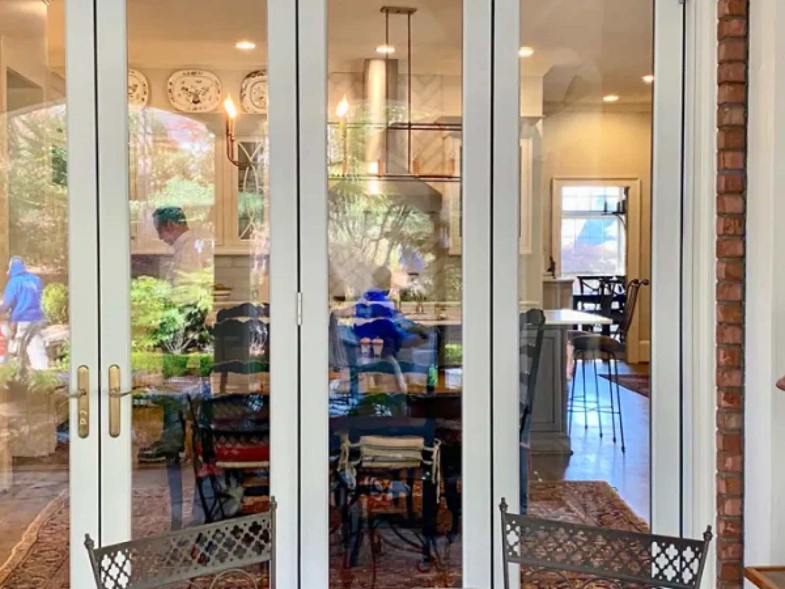 a glass door with a table and chairs in front of it