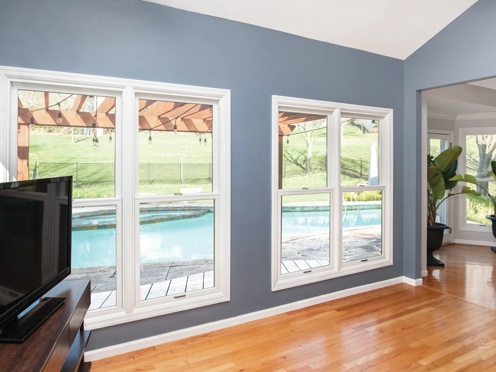 a living room with a tv and a large window
