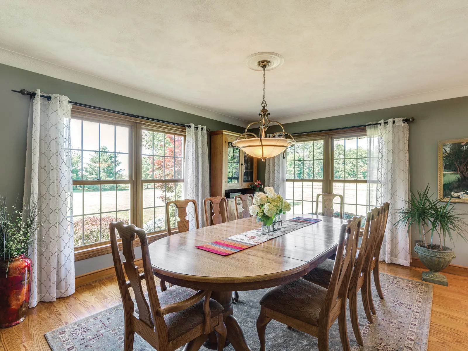 Athens, GA fiberglass windows with wood interior finish in a dining room with wood dining table and chairs.
