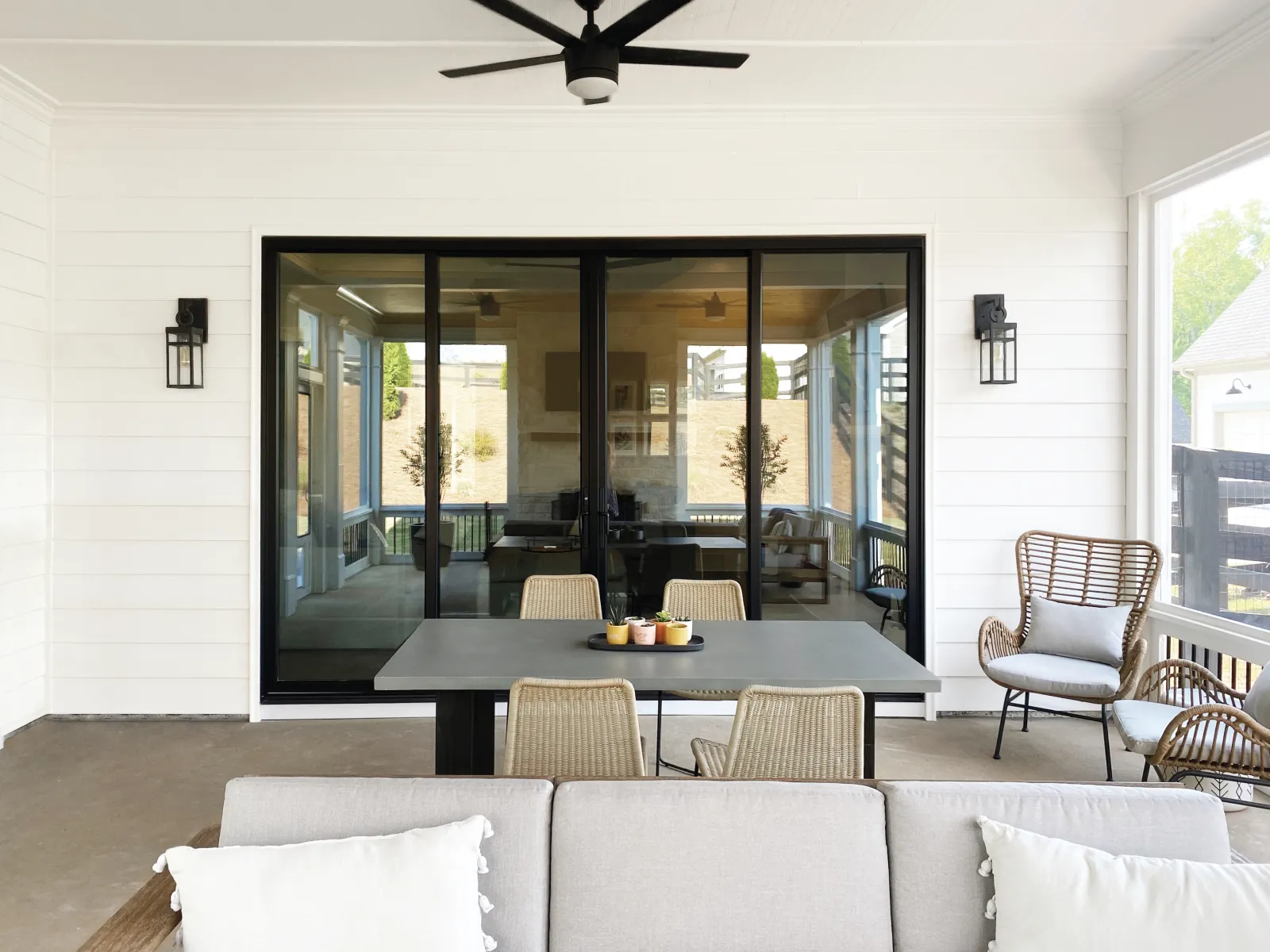 Infinity from Marvin black sliding glass patio doors installed between indoor and outdoor living areas.