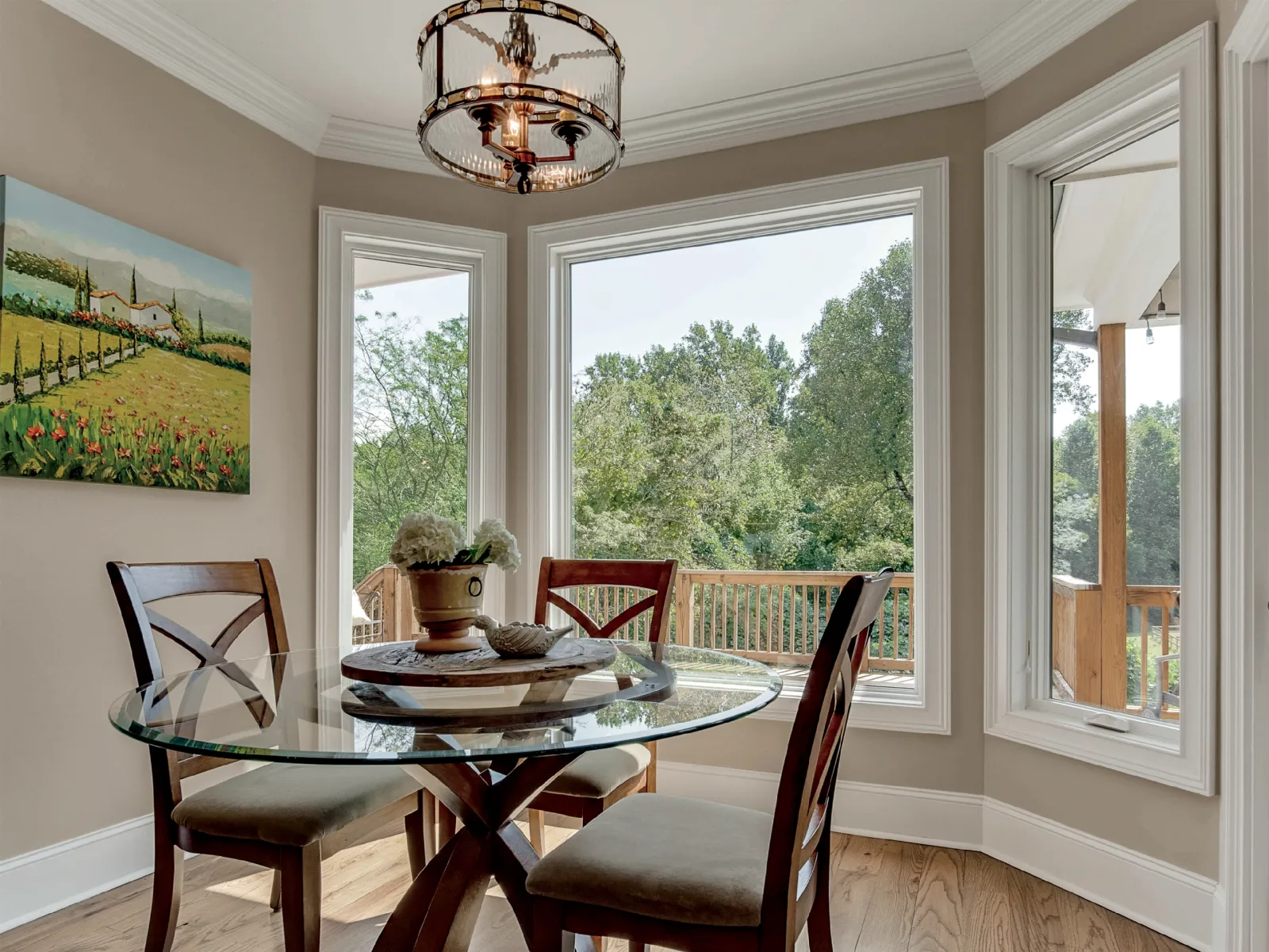 White fiberglass casement windows with a white picture window in the center with dining table in front