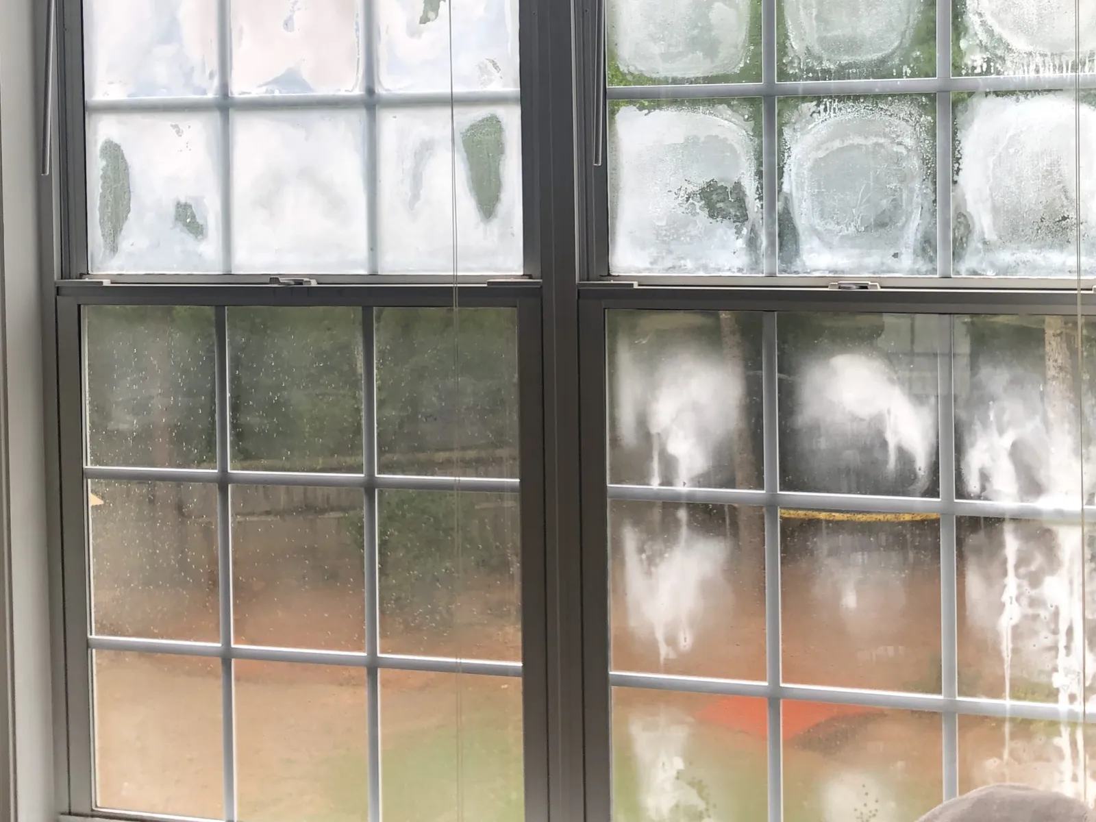 a window with condensation caused by cold air outside and warm air inside