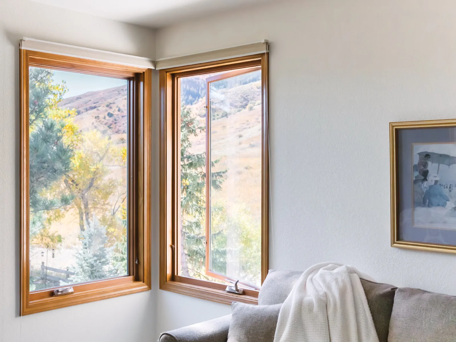 2 casement windows in the corner of a room with EverWood stainable synthetic wood interior finish overlooking the hills and trees outside.