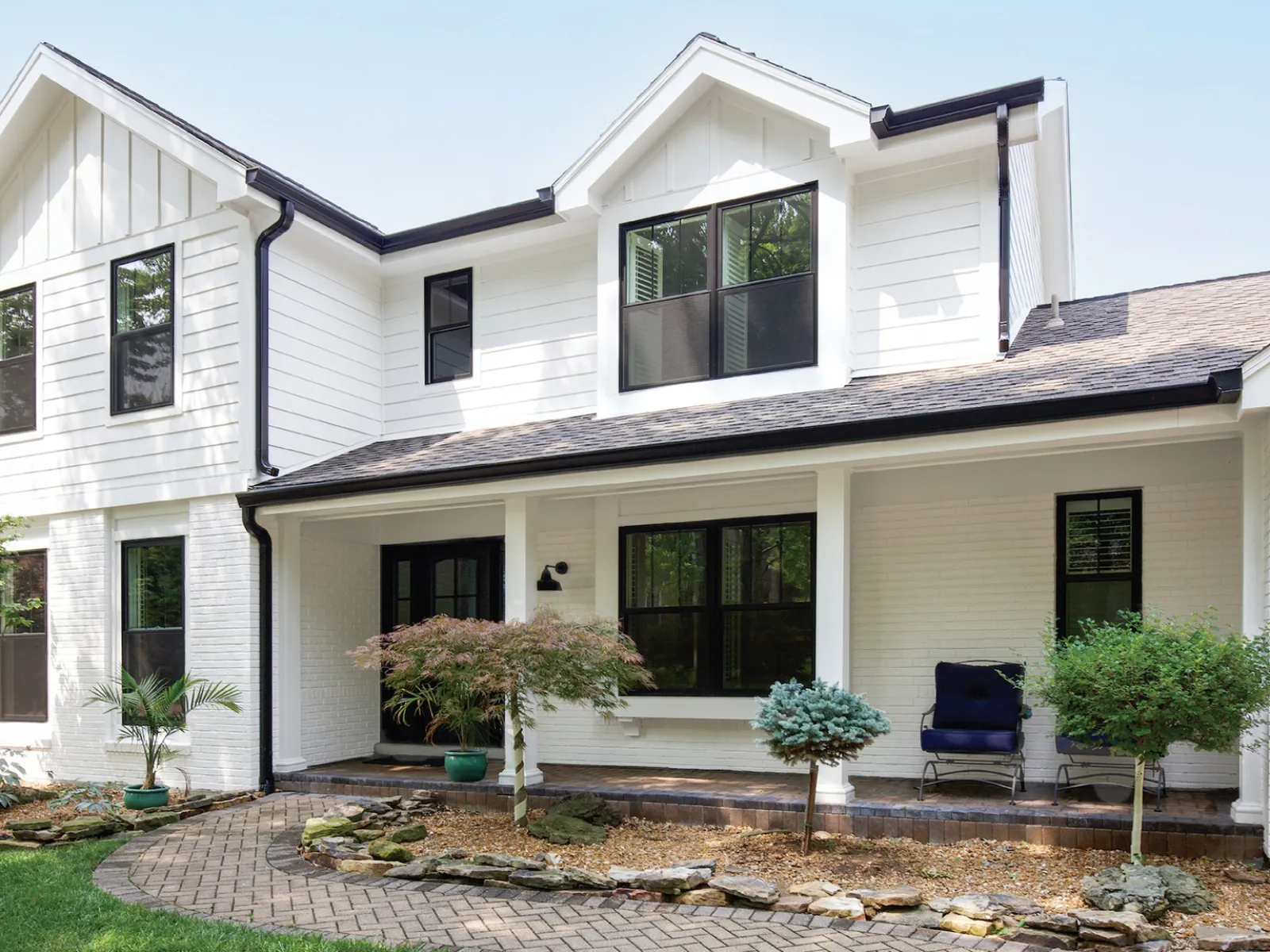 a house with a yard and a chair in the front