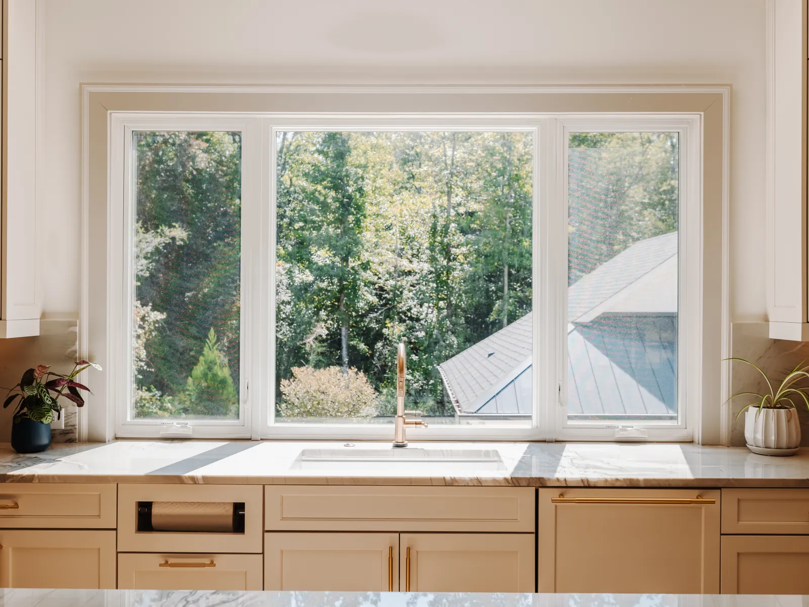 White fiberglass casement windows installed above a sink by North Georgia Replacement Windows