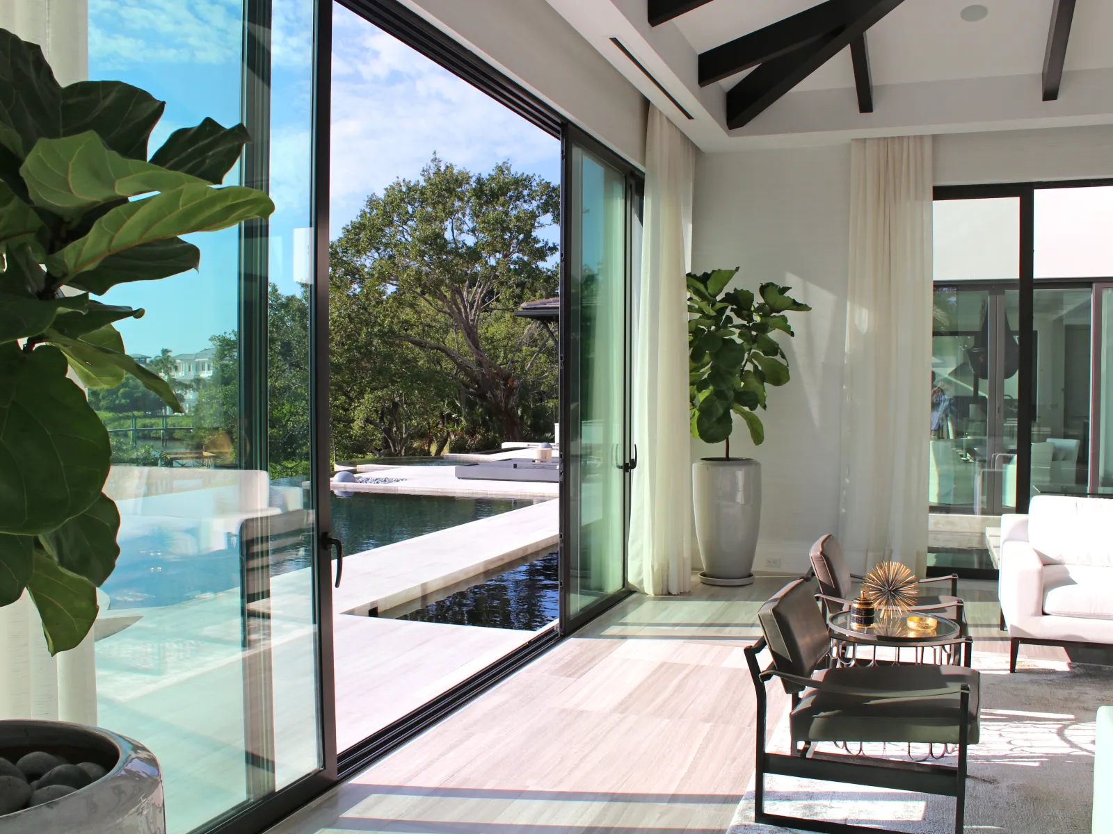 a room with a glass door and a large glass window
