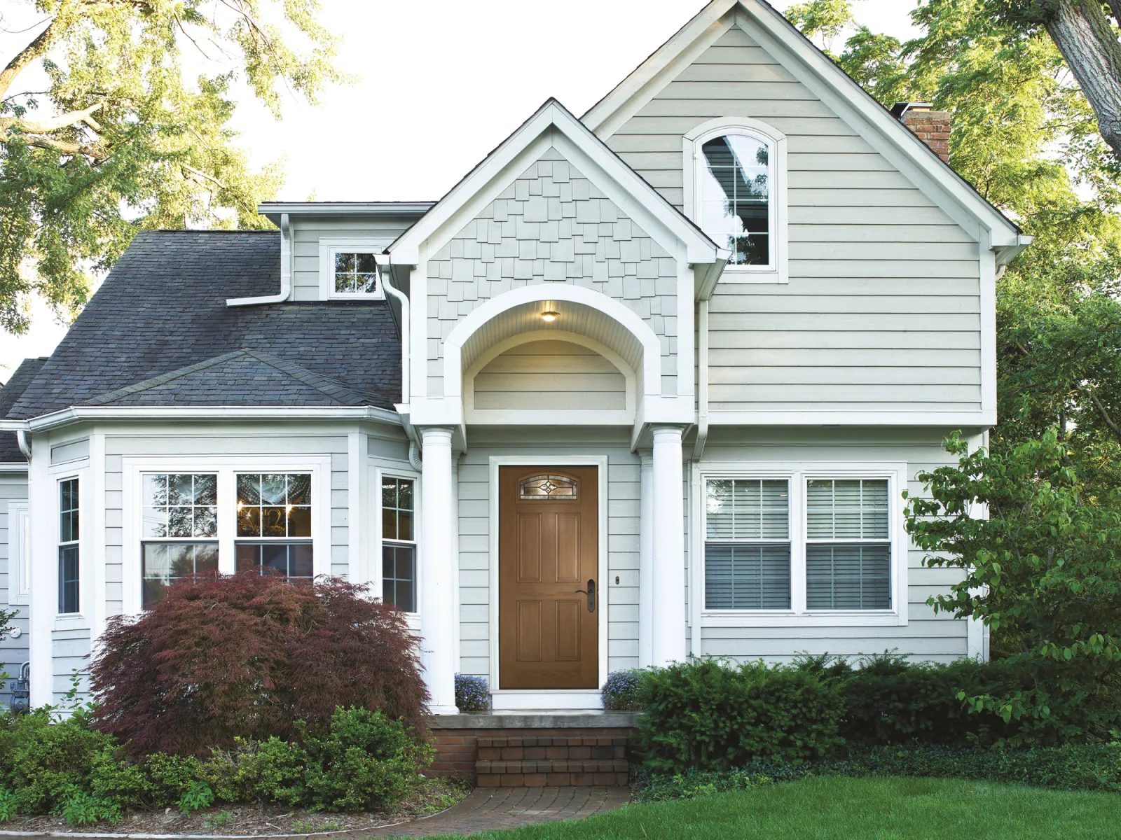 a white house with a large front yard