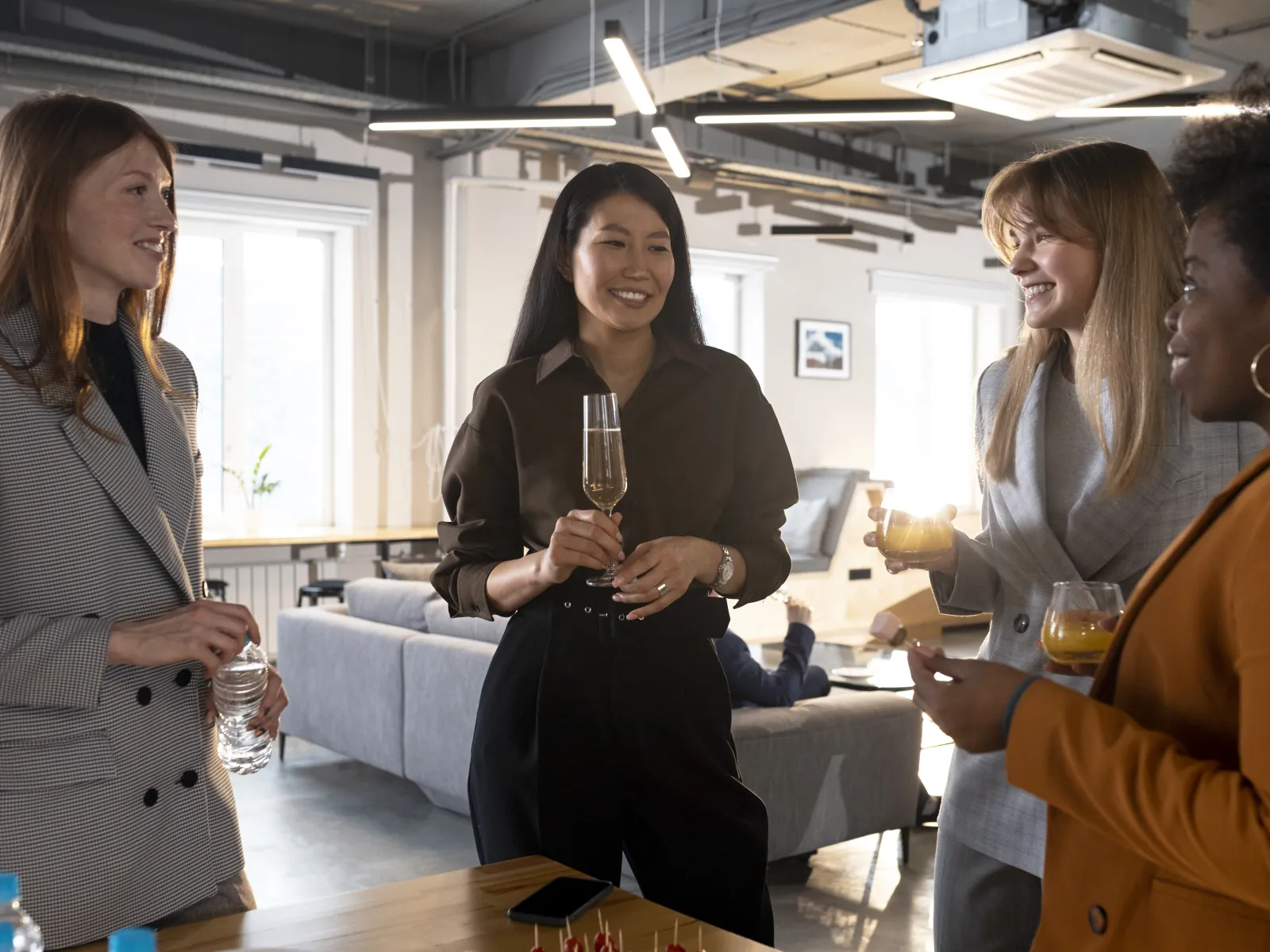 a group of women holding glasses of wine