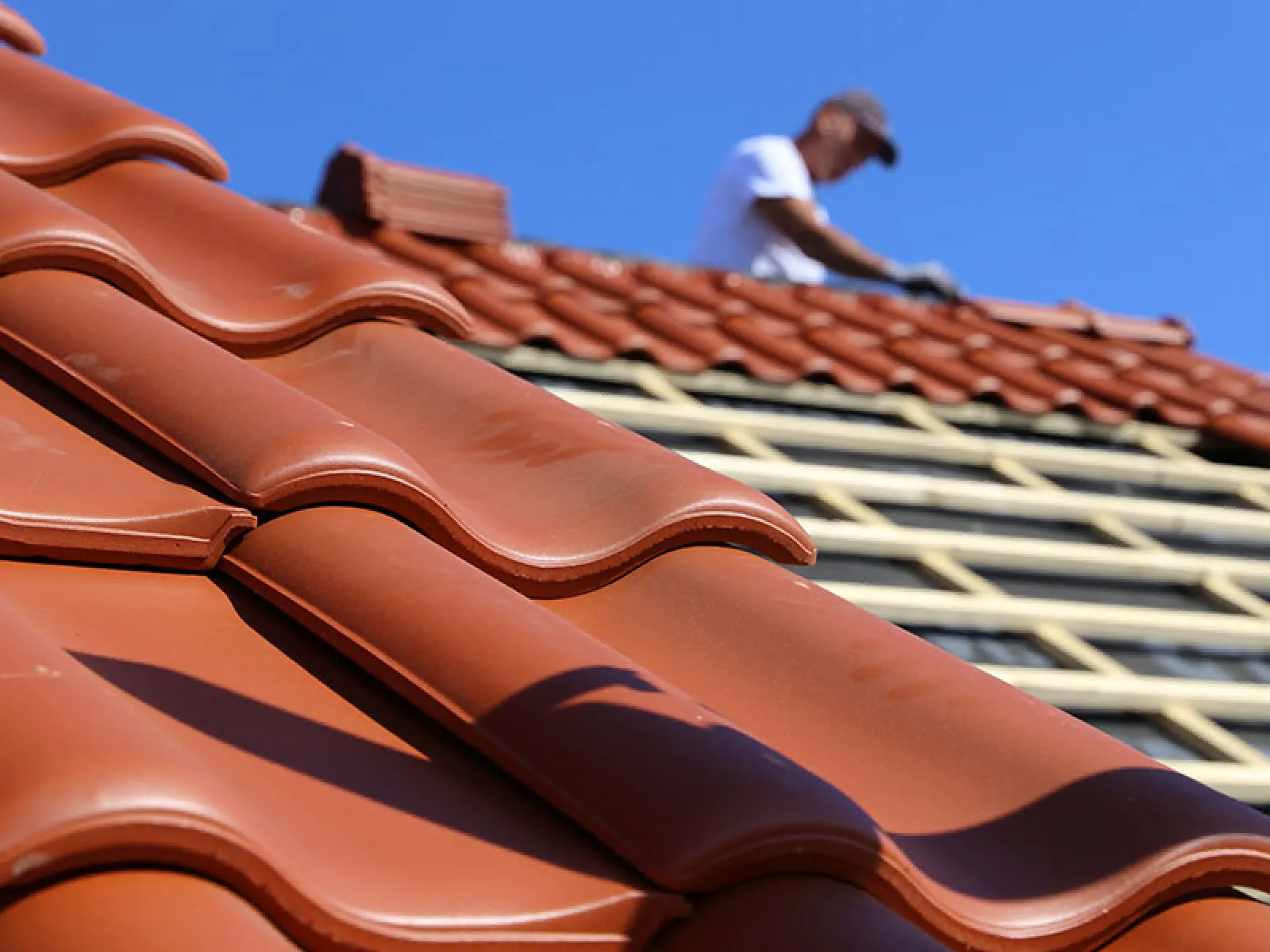 roofer working on tile roof restoration in florida
