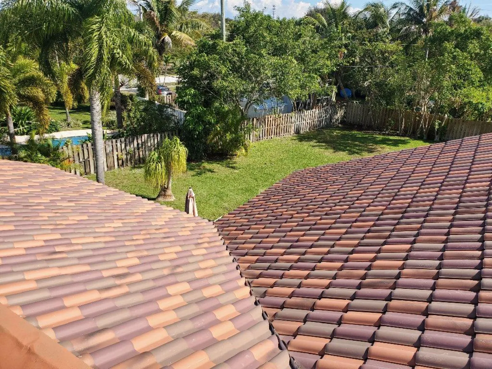 a florida roof with a brick walkway and trees in the background