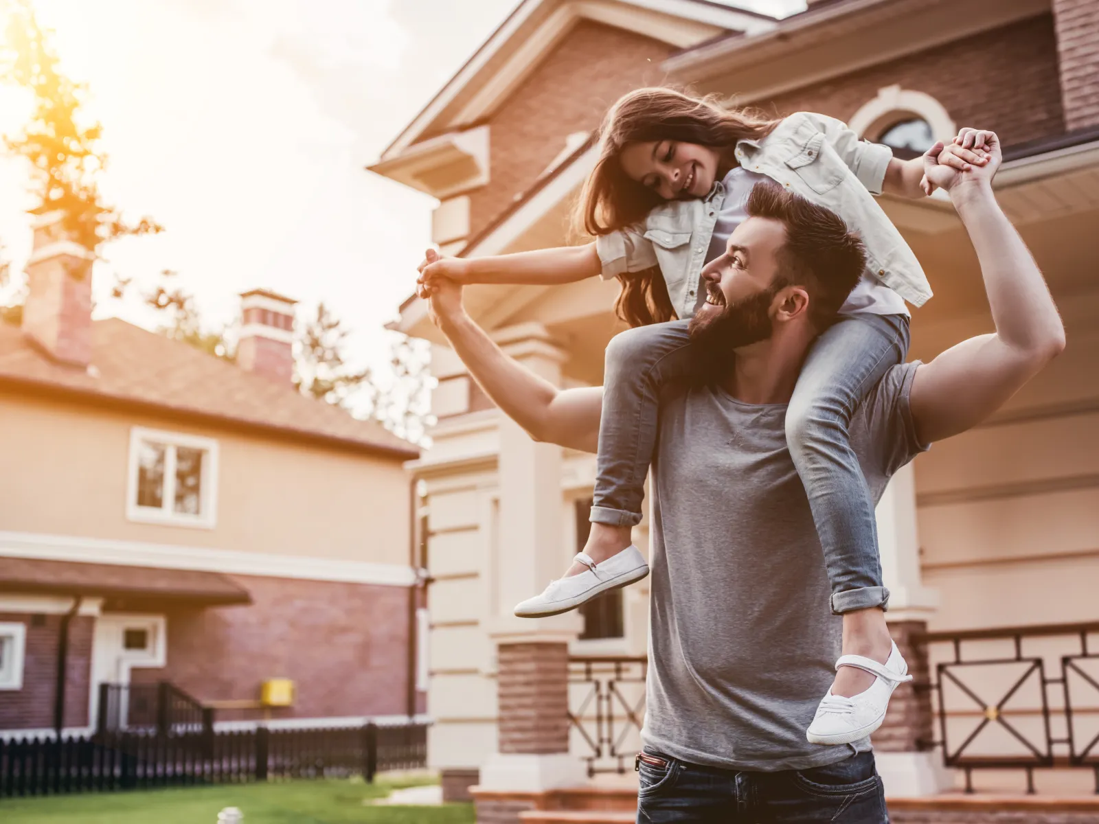 a family posing in front of a house
