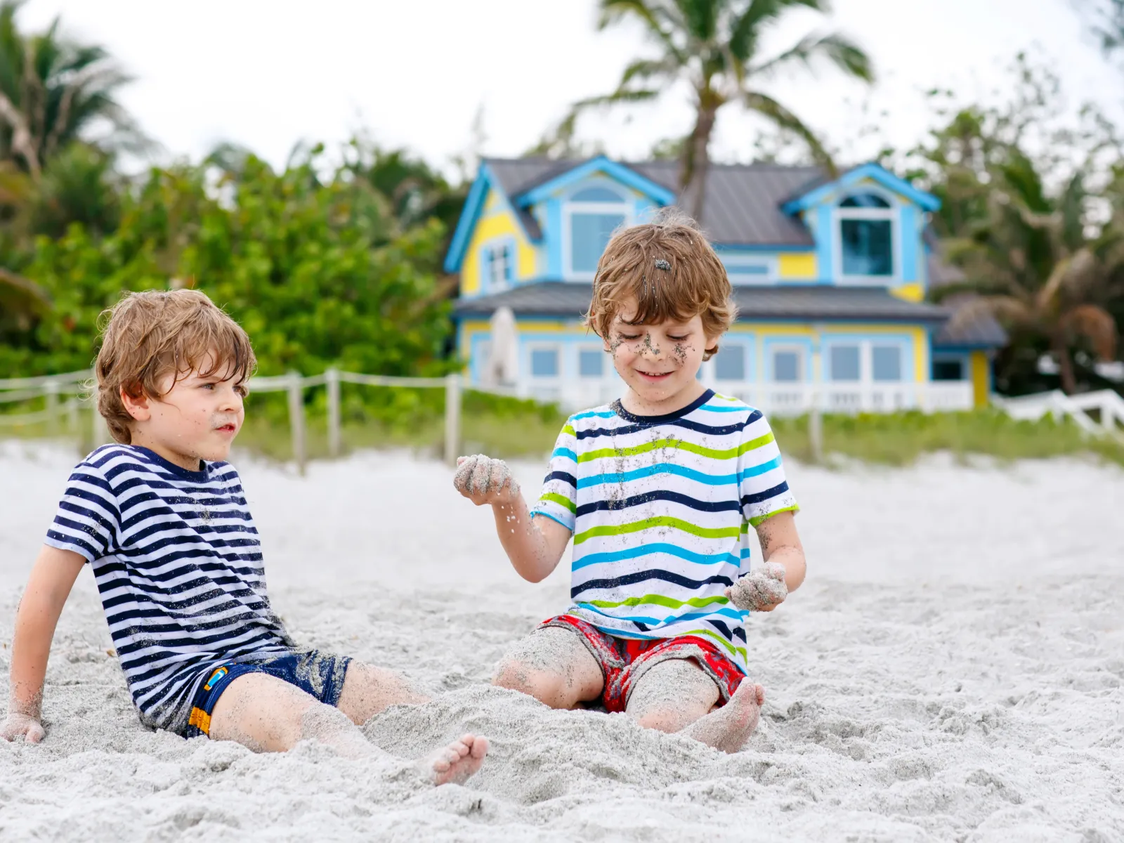 two boys playing in the sand in florida