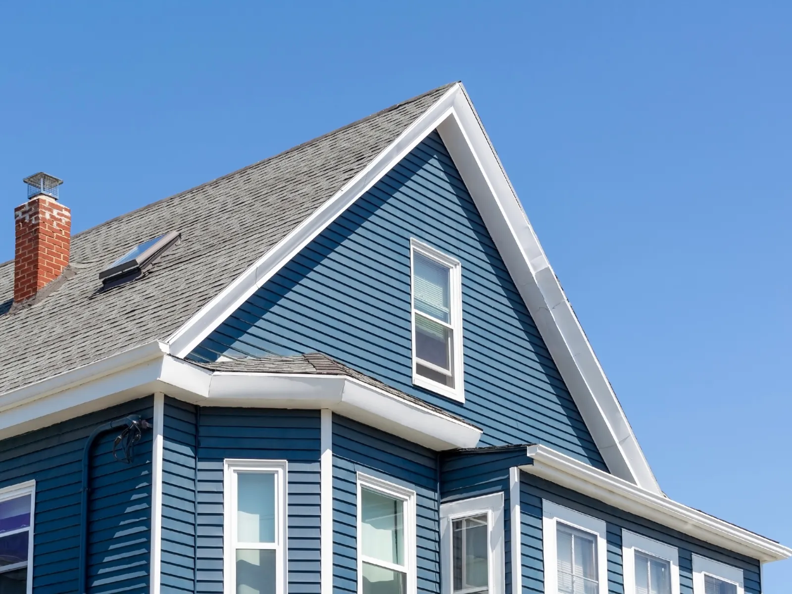 a blue house with a chimney