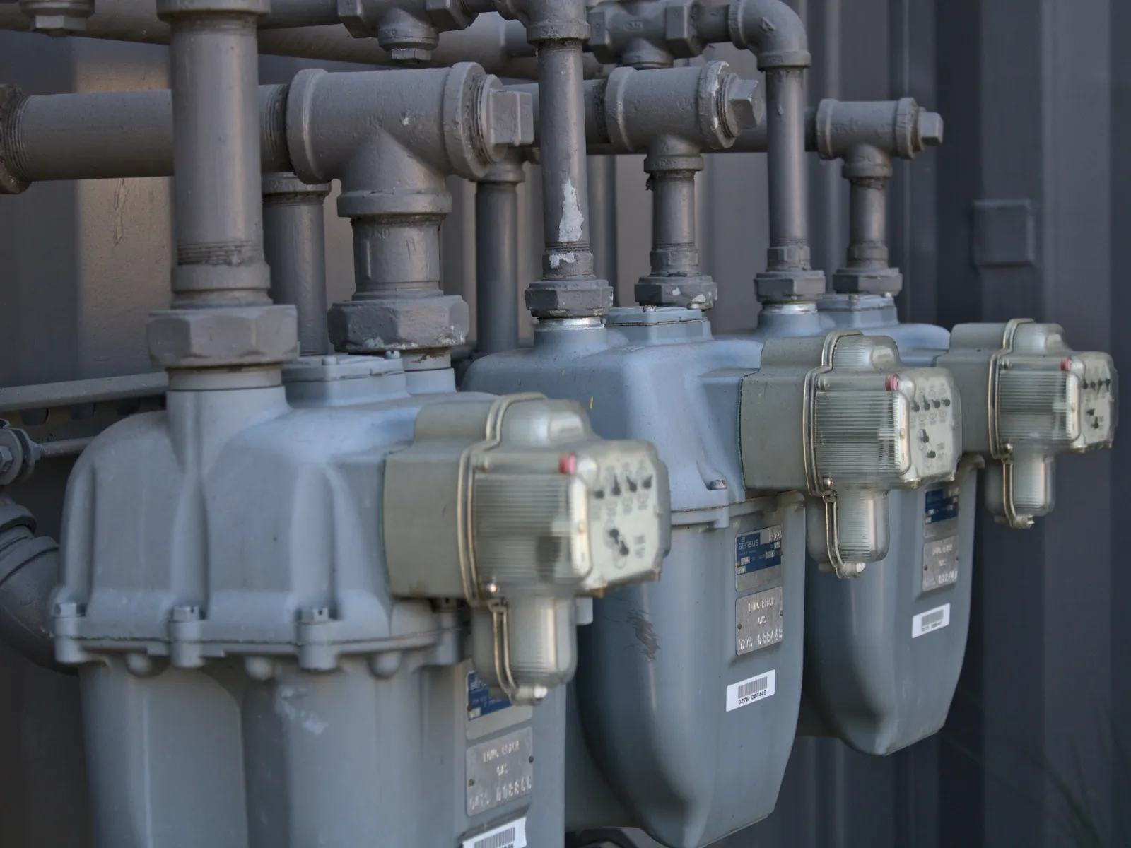 several metal pipes with labels