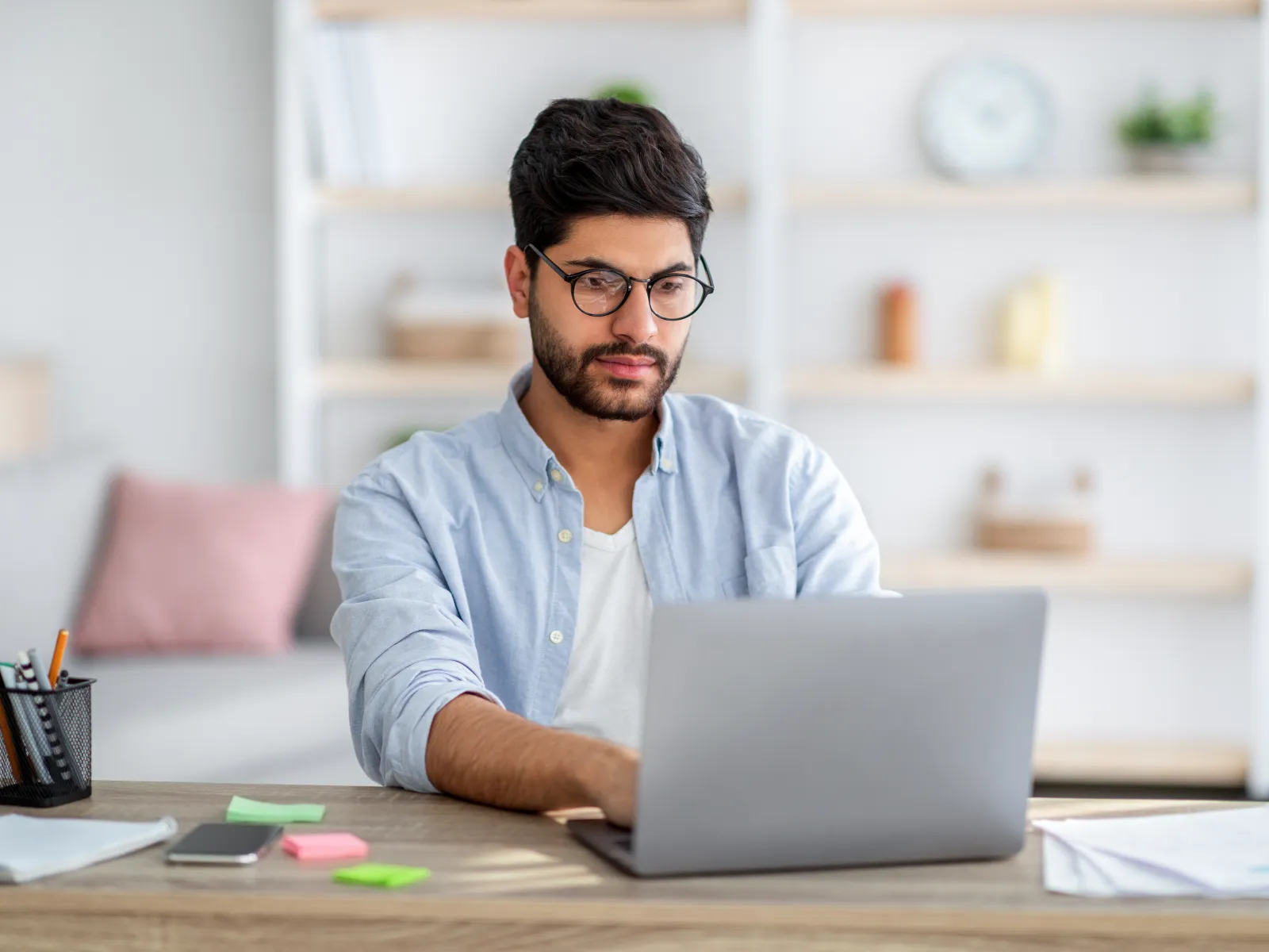 a person sitting at a desk with a laptop