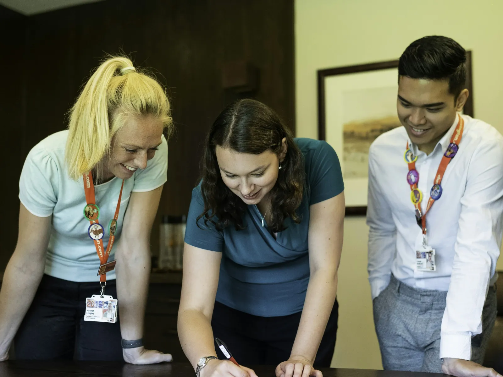 a group of people looking at a paper