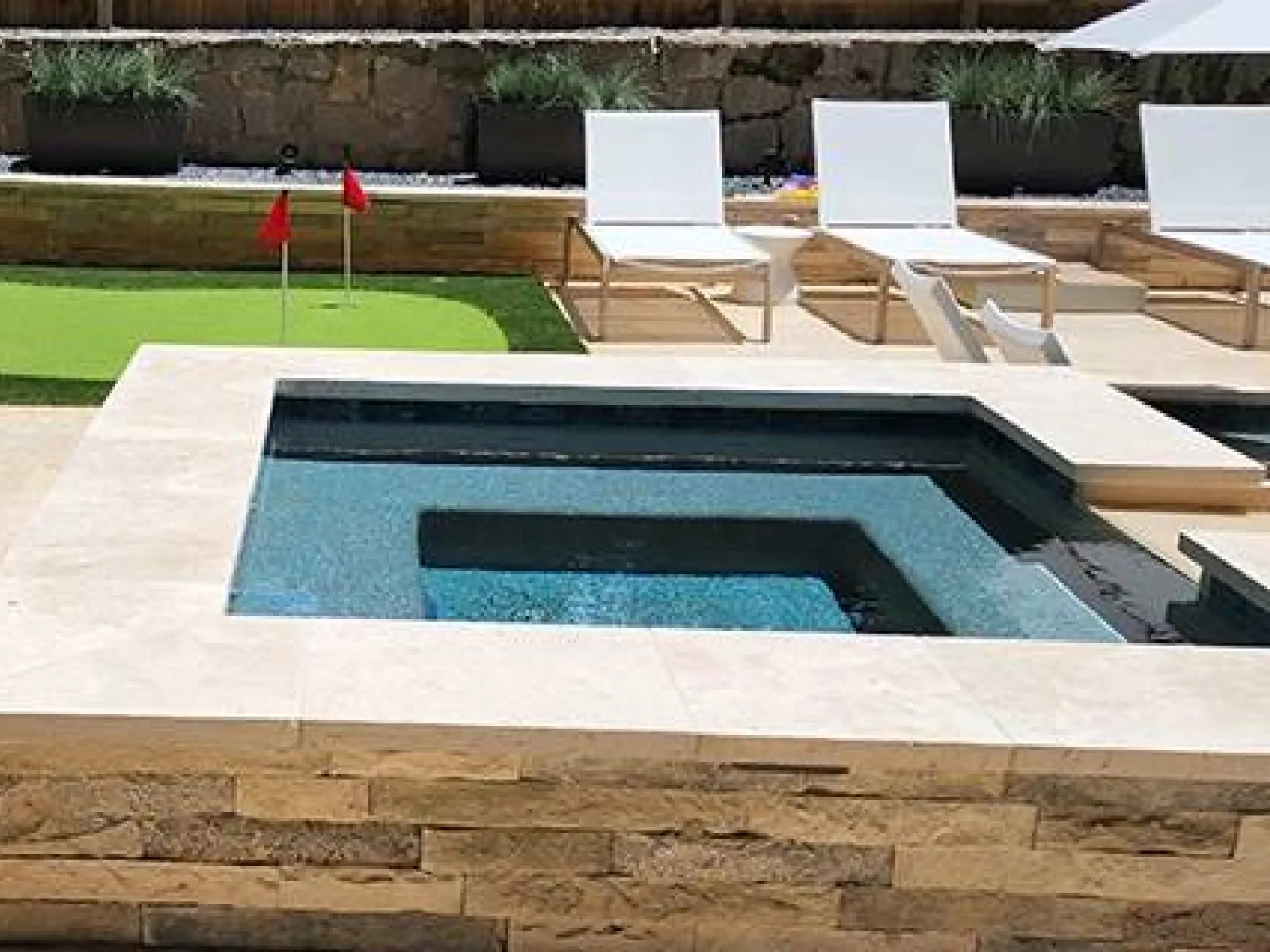 a pool with chairs around it