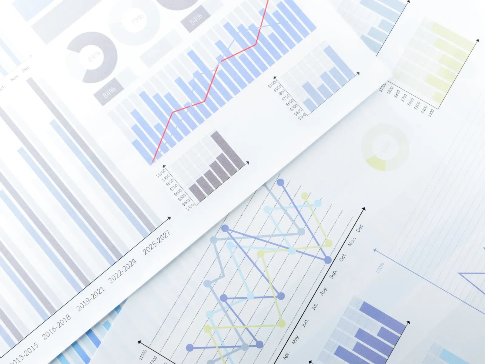Various graphs and charts displaying data trends and statistics on paper sheets.