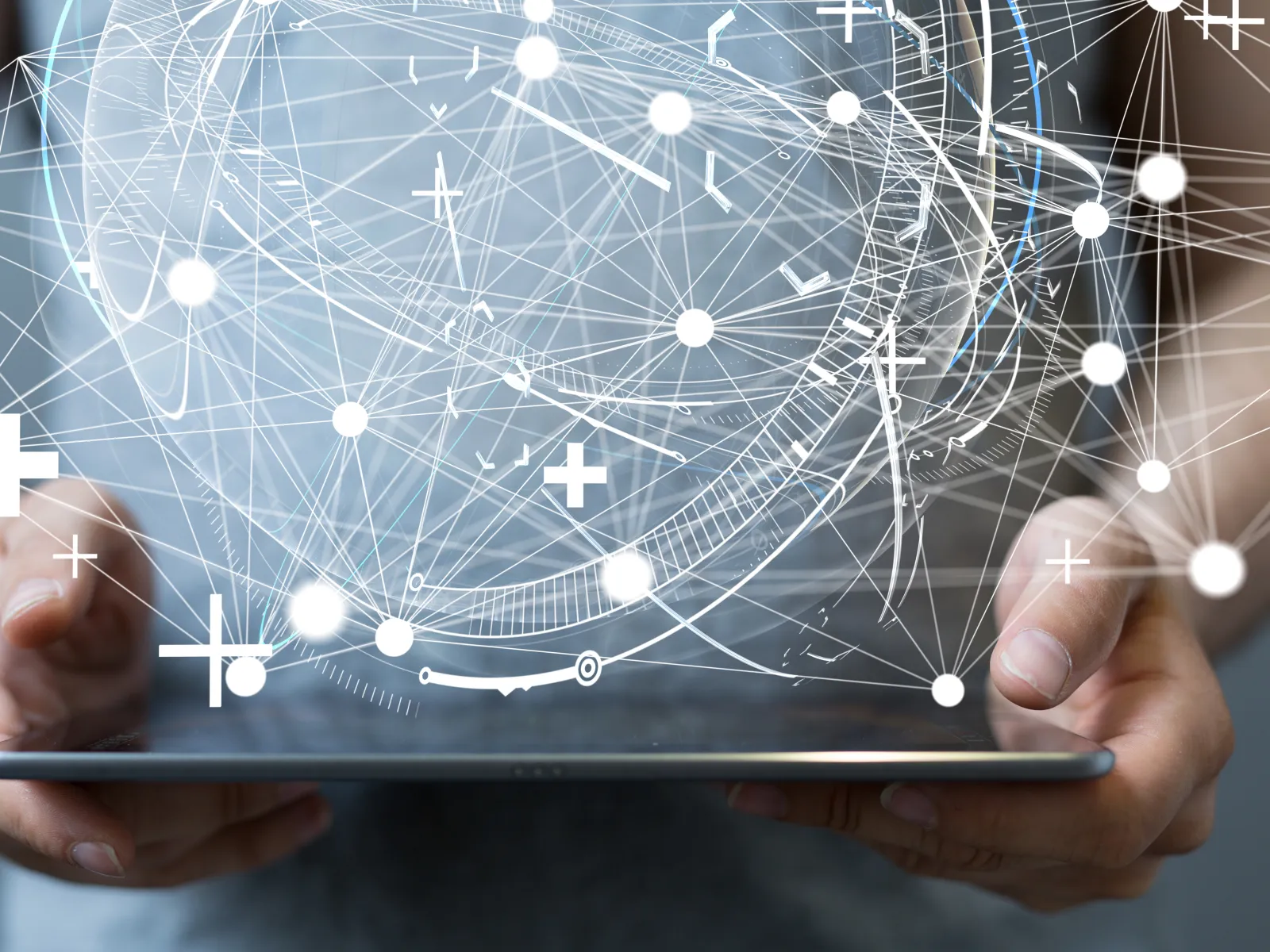 Person holding tablet with abstract digital connections and data visualization above it.