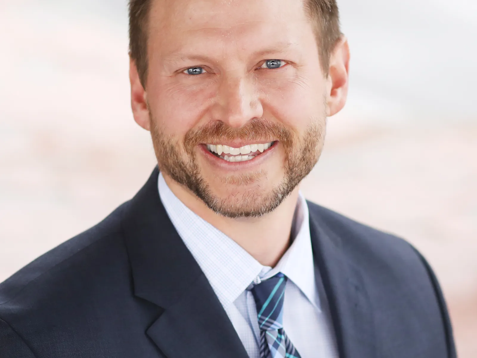 a man in a suit smiling