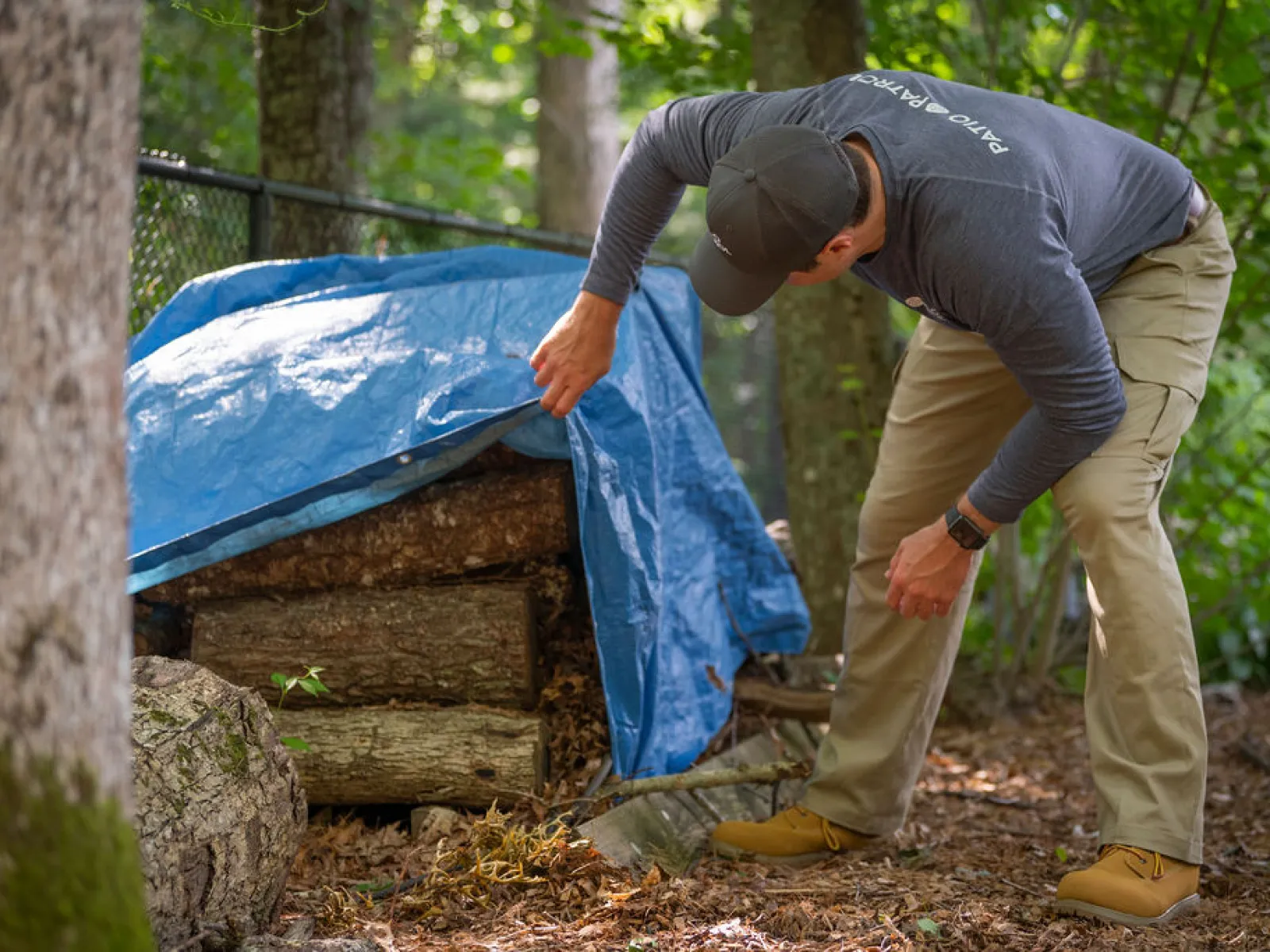 a man bending over a tree stump
