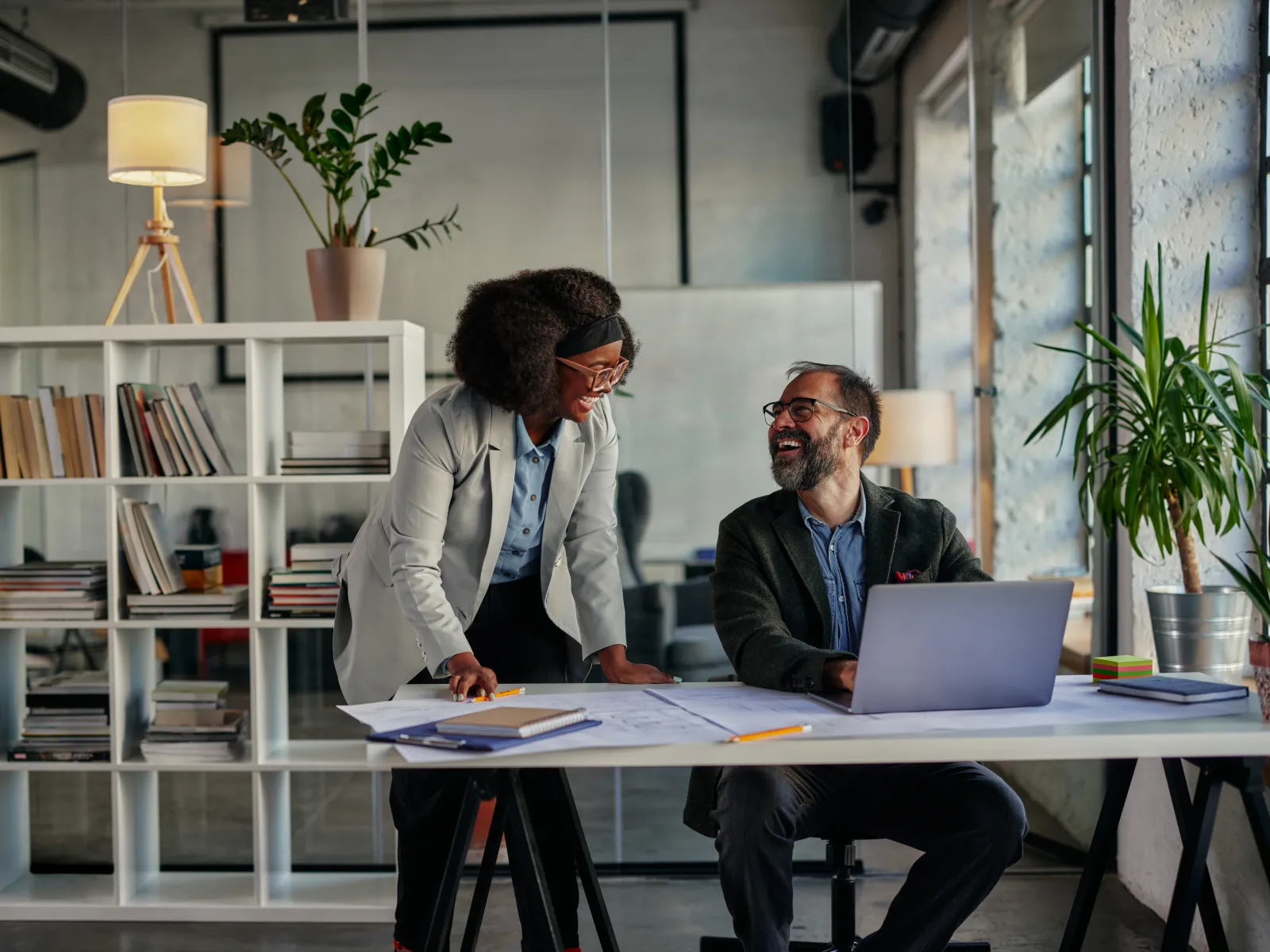 a man and a woman looking at a laptop