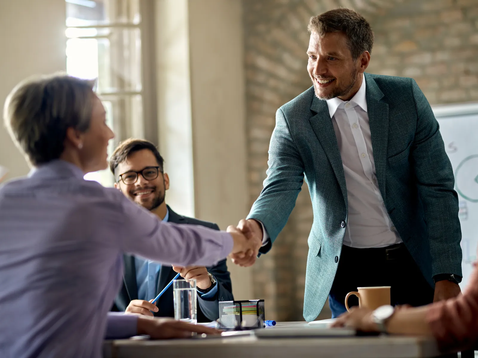 a man shaking hands with a woman