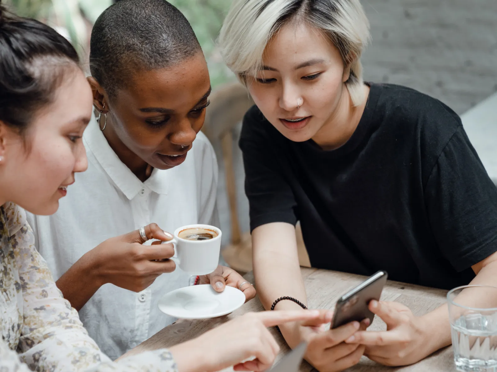 a group of people looking at a phone