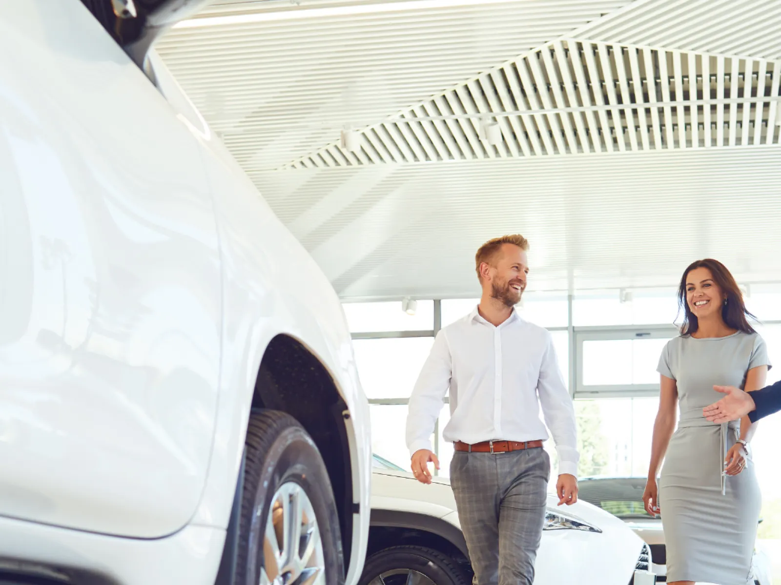a man and a woman standing next to a car