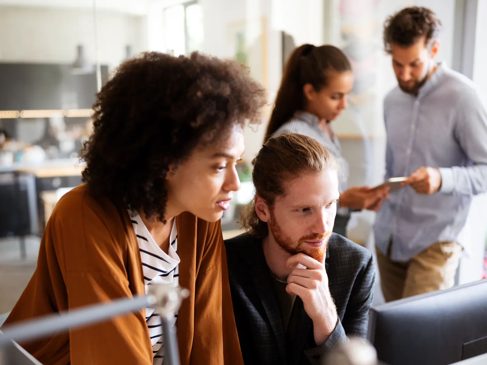 a group of people looking at a computer screen