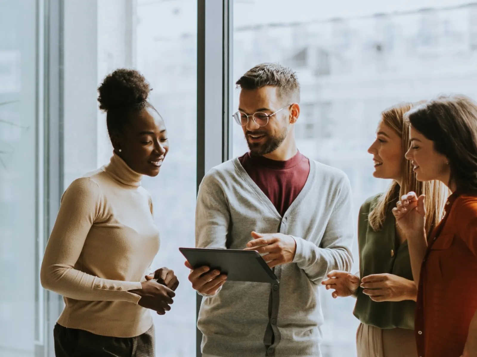a group of people talking in an office