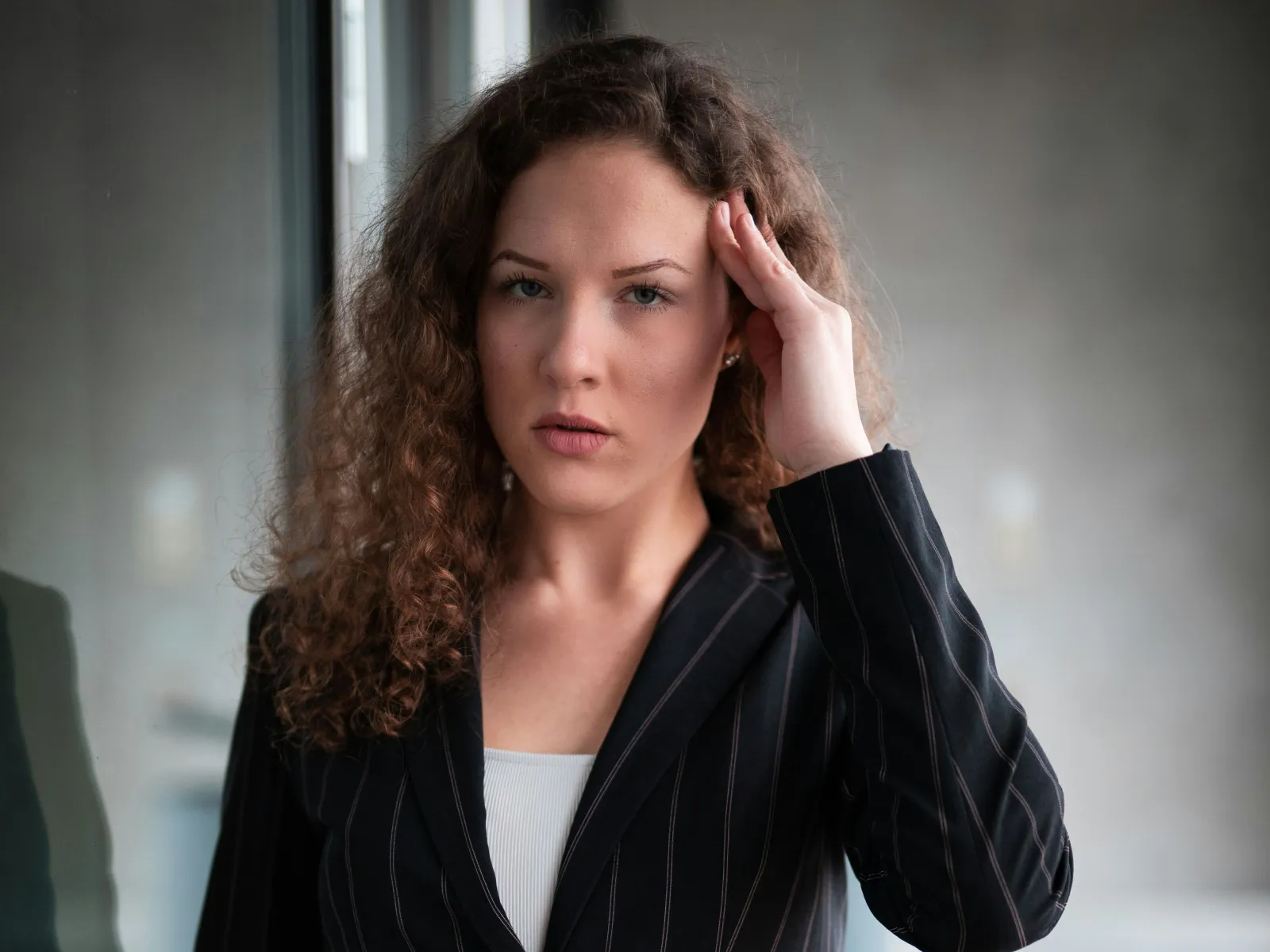 a woman with her hand on her face