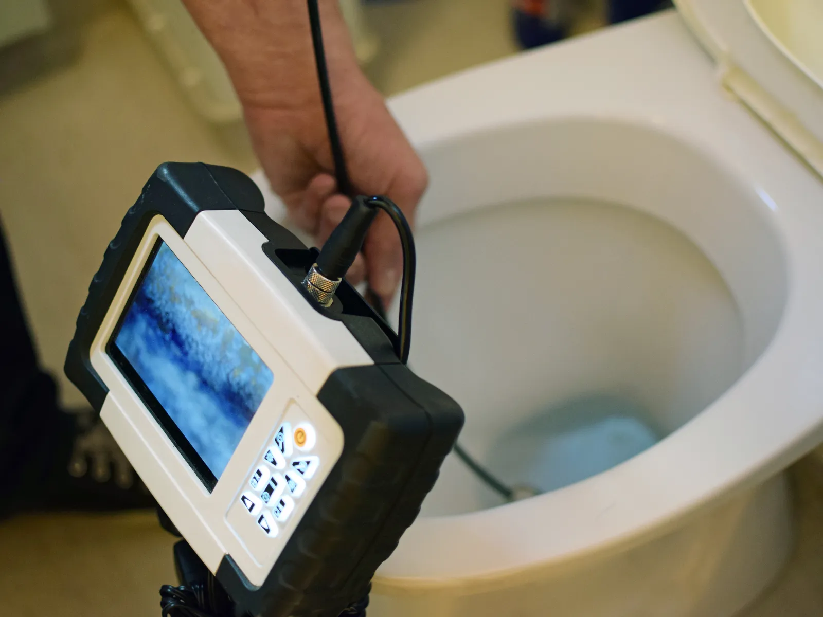 a person using a phone in a toilet