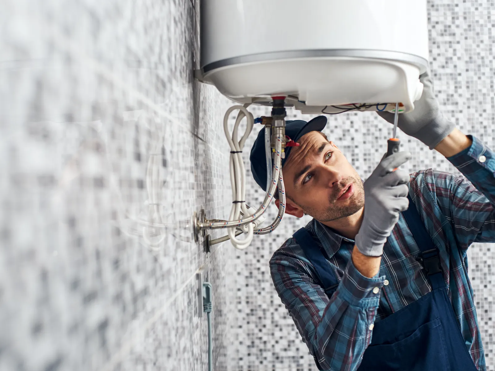 a person fixing a water heater