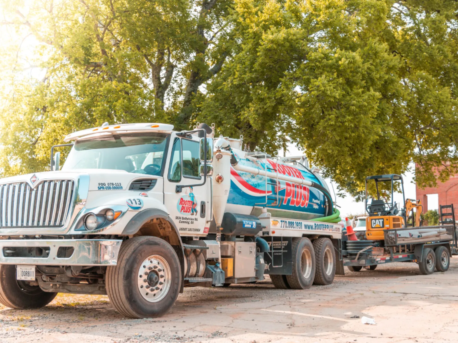 a large truck is parked next to a construction vehicle