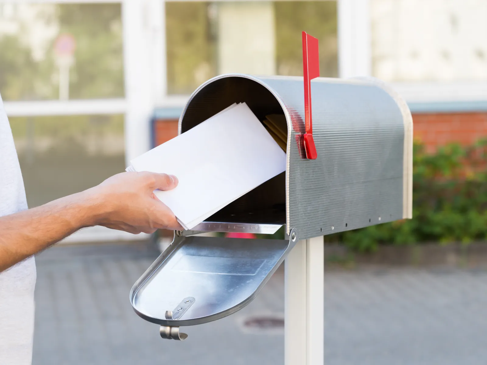 a hand holding a piece of mail