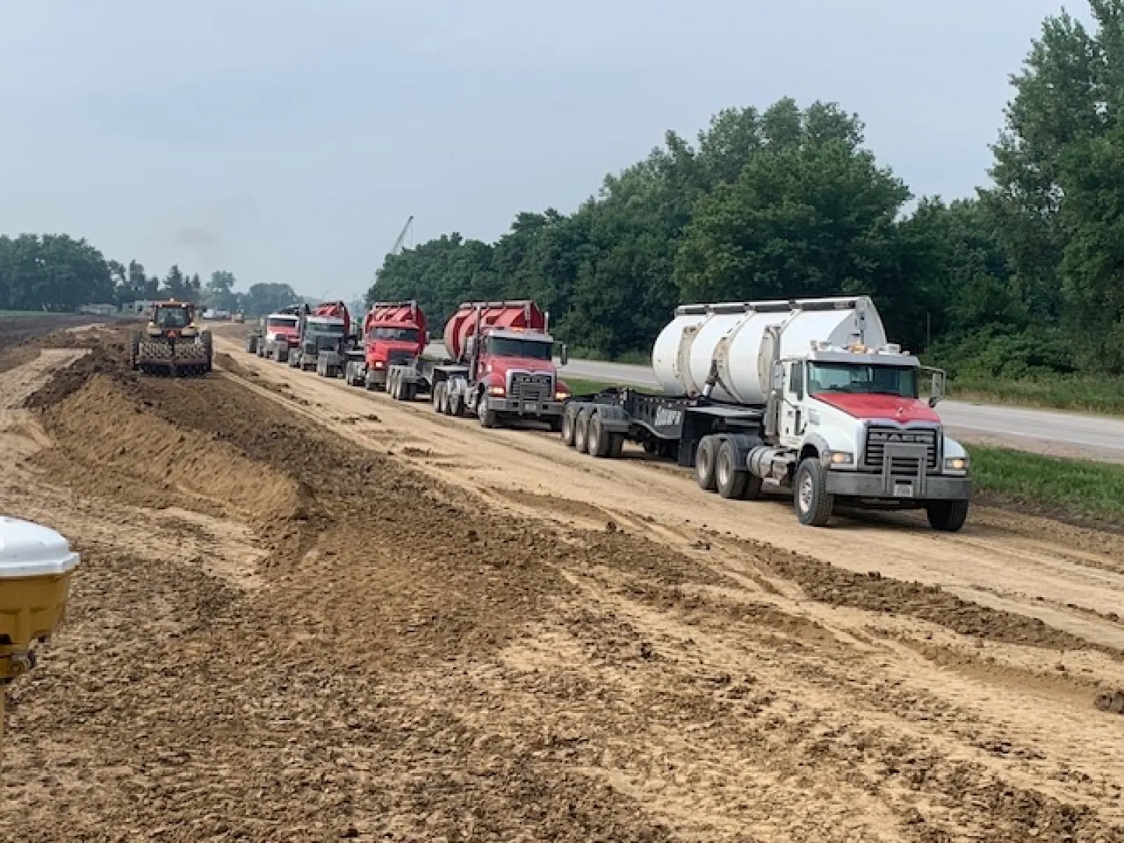 a group of trucks on a dirt road