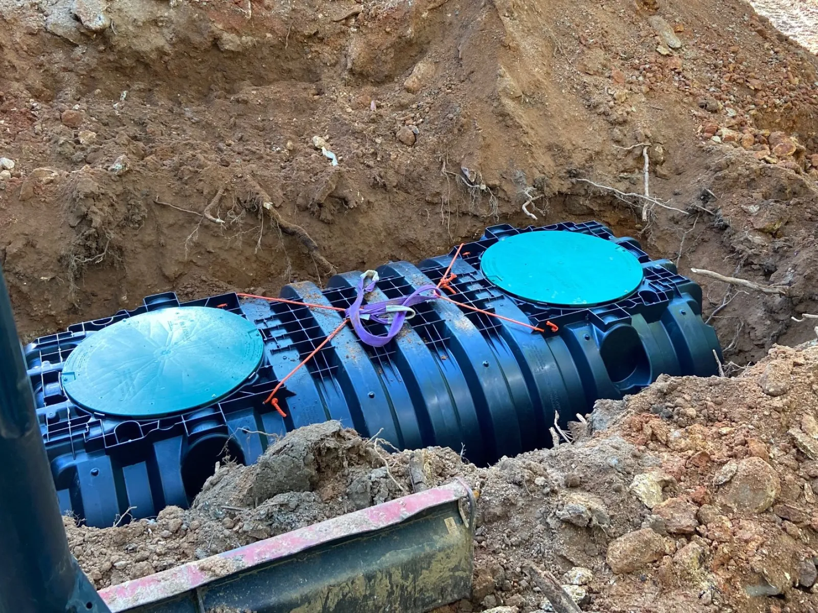 a blue septic tank installed in the ground in Metro Atlanta