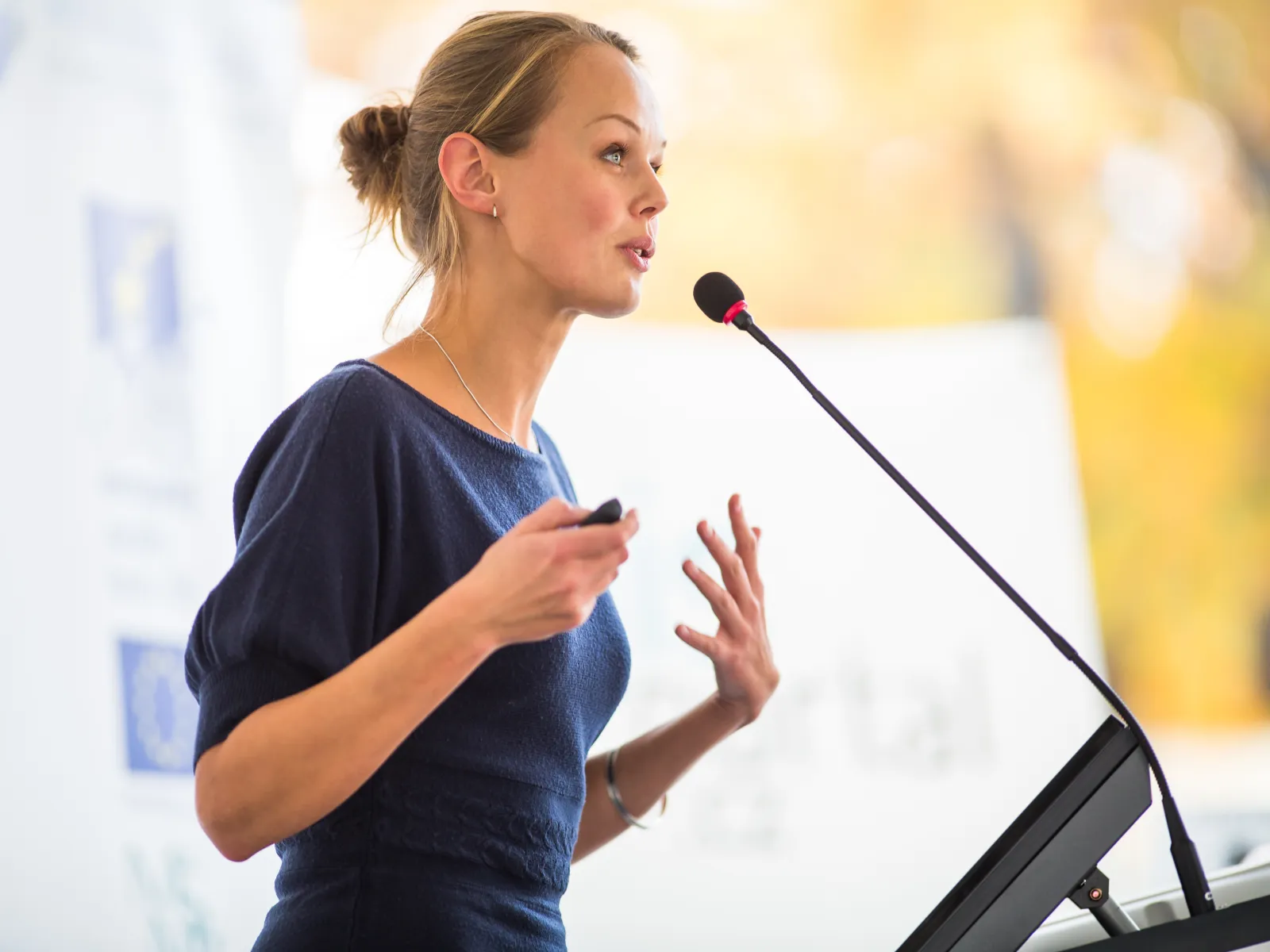 a woman speaking into a microphone