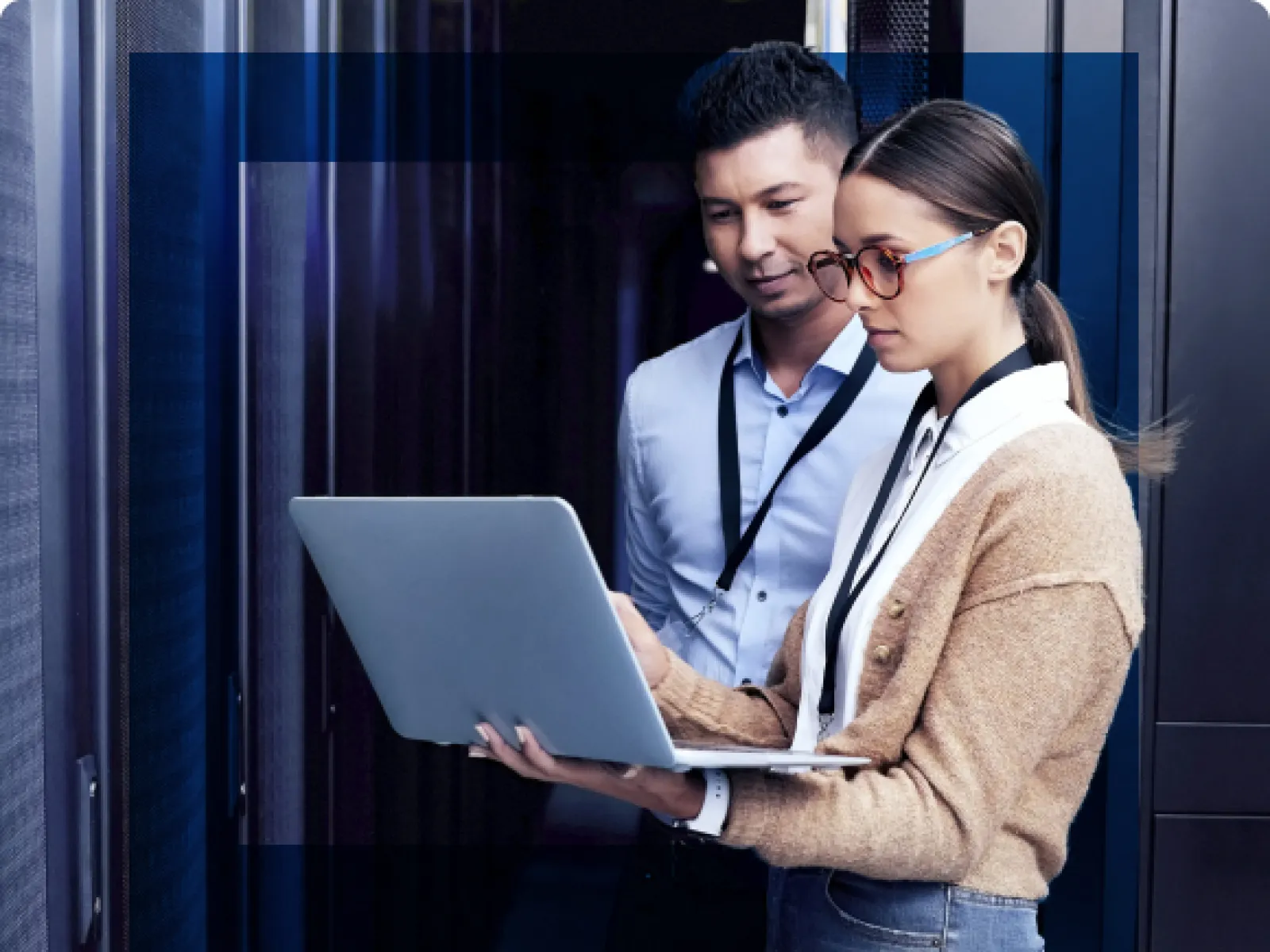 a man and a woman looking at a laptop